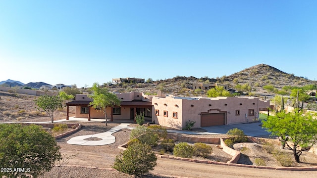 28758 N Ashbrook Ln, San Tan Valley, AZ 85144 - view of front facade featuring stucco siding, a garage, driveway, and a mountain view