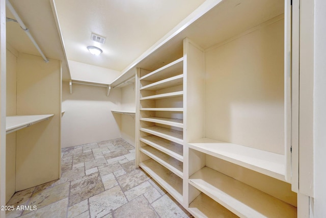 28758 N Ashbrook Ln, San Tan Valley, AZ 85144 - walk in closet featuring stone tile flooring