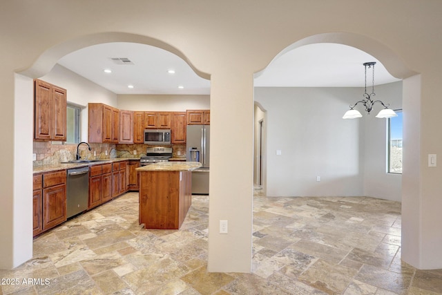 28758 N Ashbrook Ln, San Tan Valley, AZ 85144 - kitchen with appliances with stainless steel finishes, arched walkways, a sink, healthy amount of natural light, and recessed lighting