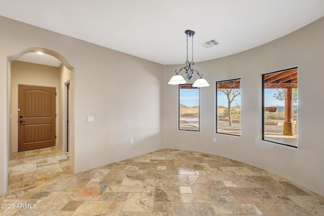 28758 N Ashbrook Ln, San Tan Valley, AZ 85144 - spare room featuring stone tile floors and arched walkways