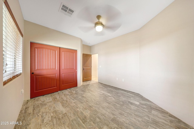 28758 N Ashbrook Ln, San Tan Valley, AZ 85144 - unfurnished bedroom with wood finished floors, a closet, and a ceiling fan