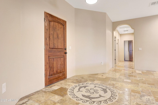 28758 N Ashbrook Ln, San Tan Valley, AZ 85144 - hallway with stone tile flooring and arched walkways