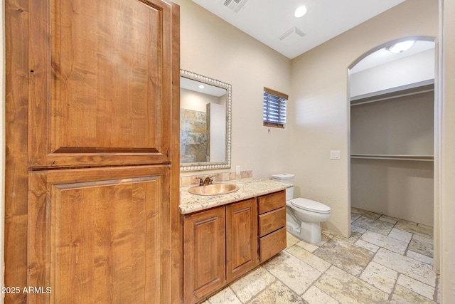 28758 N Ashbrook Ln, San Tan Valley, AZ 85144 - full bathroom featuring toilet, stone tile flooring, vanity, and recessed lighting