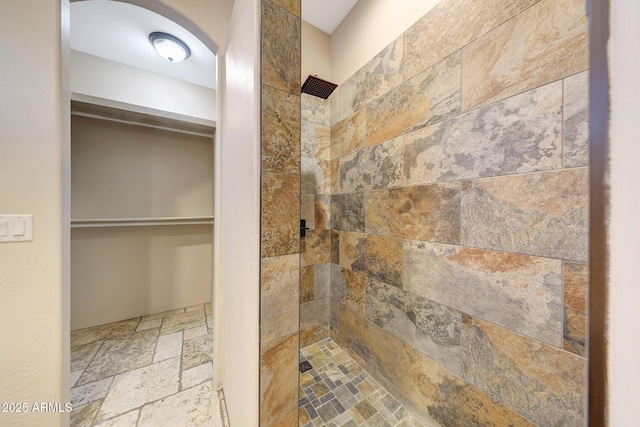 28758 N Ashbrook Ln, San Tan Valley, AZ 85144 - bathroom with stone tile floors, a tile shower, and a walk in closet
