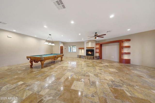 28758 N Ashbrook Ln, San Tan Valley, AZ 85144 - recreation room with stone tile floors, a ceiling fan, recessed lighting, a warm lit fireplace, and billiards table