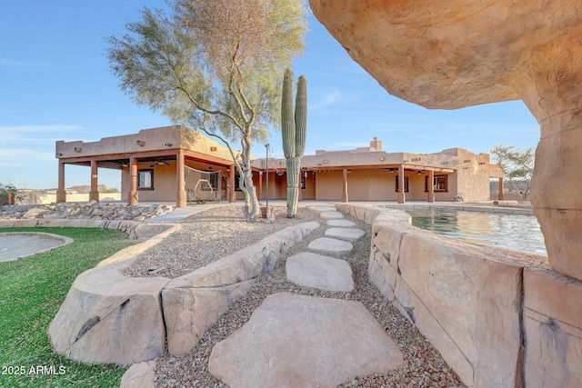 28758 N Ashbrook Ln, San Tan Valley, AZ 85144 - rear view of house with a ceiling fan, a patio, an outdoor pool, and a chimney