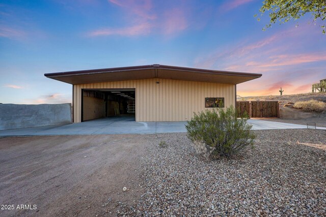 28758 N Ashbrook Ln, San Tan Valley, AZ 85144 - garage at dusk featuring driveway and a detached garage