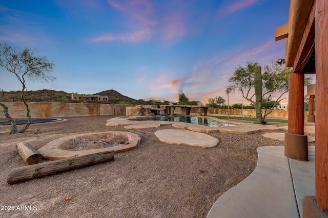 28758 N Ashbrook Ln, San Tan Valley, AZ 85144 - yard at dusk featuring a patio area and a fenced backyard