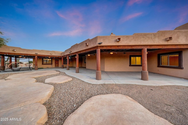 28758 N Ashbrook Ln, San Tan Valley, AZ 85144 - back of house at dusk with a patio area