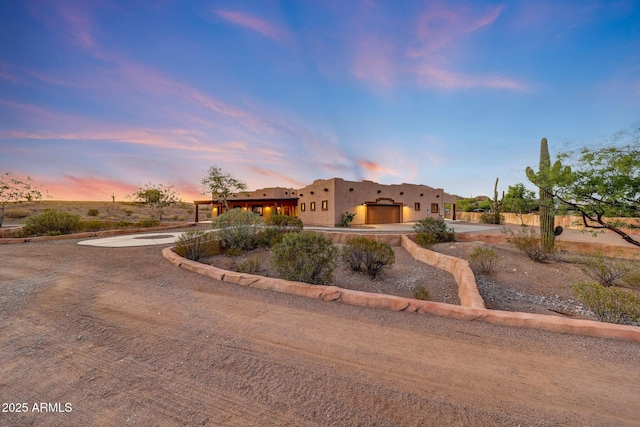 28758 N Ashbrook Ln, San Tan Valley, AZ 85144 - pueblo-style house with curved driveway, a garage, and stucco siding