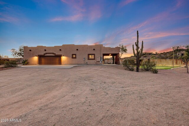 28758 N Ashbrook Ln, San Tan Valley, AZ 85144 - pueblo-style home with a garage, stucco siding, and driveway