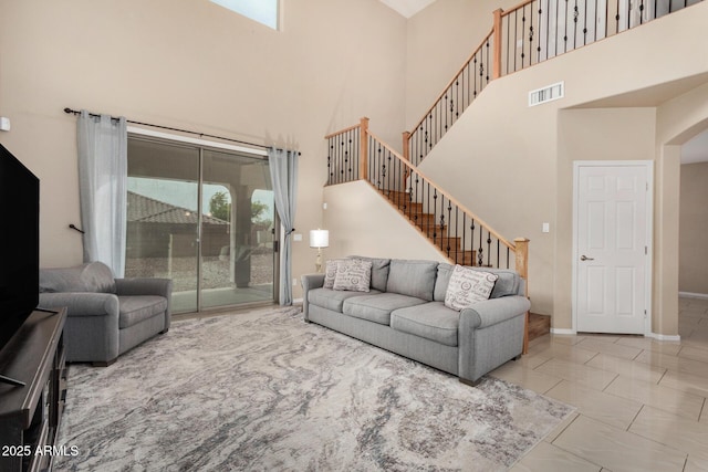 12023 W Duane Ln, Peoria, AZ 85383 - living room with a towering ceiling, marble finish flooring, stairway, and baseboards