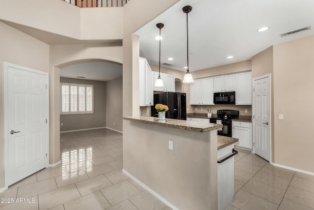 12023 W Duane Ln, Peoria, AZ 85383 - kitchen with black appliances, arched walkways, baseboards, white cabinetry, and hanging light fixtures