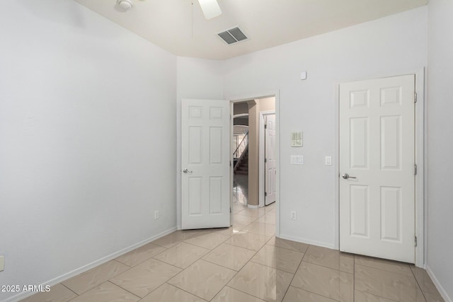 12023 W Duane Ln, Peoria, AZ 85383 - unfurnished bedroom featuring baseboards, light marble finish flooring, and ceiling fan
