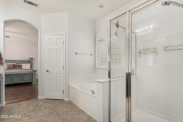 12023 W Duane Ln, Peoria, AZ 85383 - full bathroom with connected bathroom, a shower stall, a bath, and tile patterned flooring