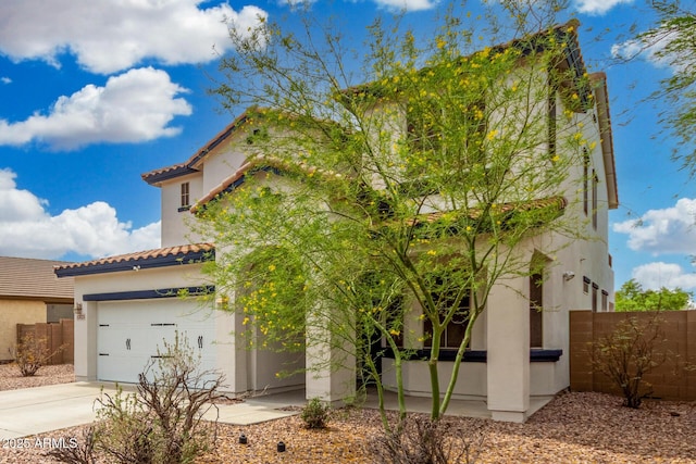 12023 W Duane Ln, Peoria, AZ 85383 - mediterranean / spanish-style house with concrete driveway, fence, a tile roof, and stucco siding