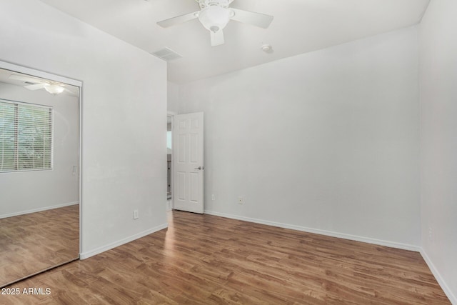 12023 W Duane Ln, Peoria, AZ 85383 - unfurnished bedroom featuring wood finished floors, baseboards, and a ceiling fan