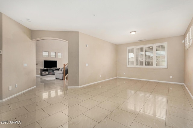 12023 W Duane Ln, Peoria, AZ 85383 - unfurnished room featuring baseboards, healthy amount of natural light, and arched walkways