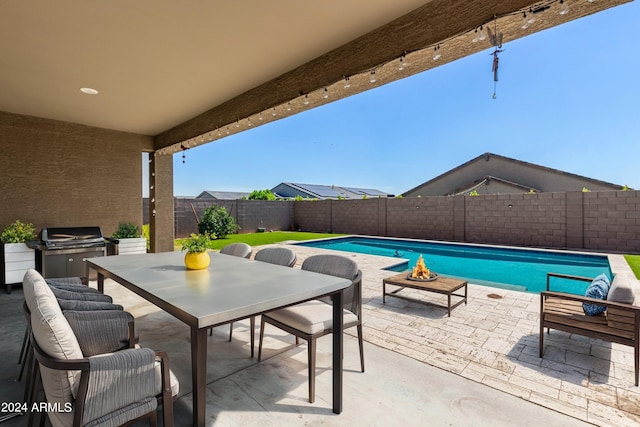 view of patio / terrace featuring area for grilling and a fenced in pool