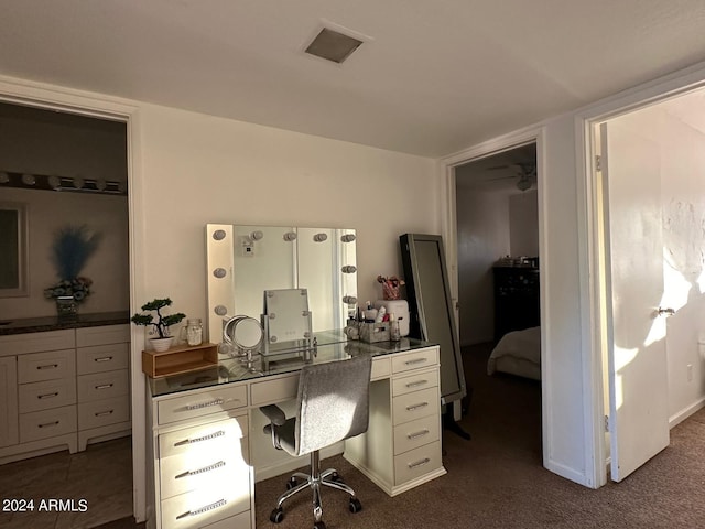 office featuring dark carpet and ceiling fan