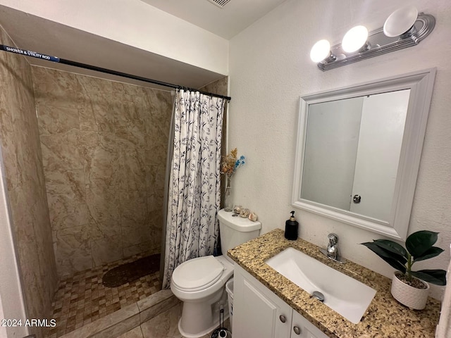 bathroom with tile patterned floors, a shower with curtain, vanity, and toilet