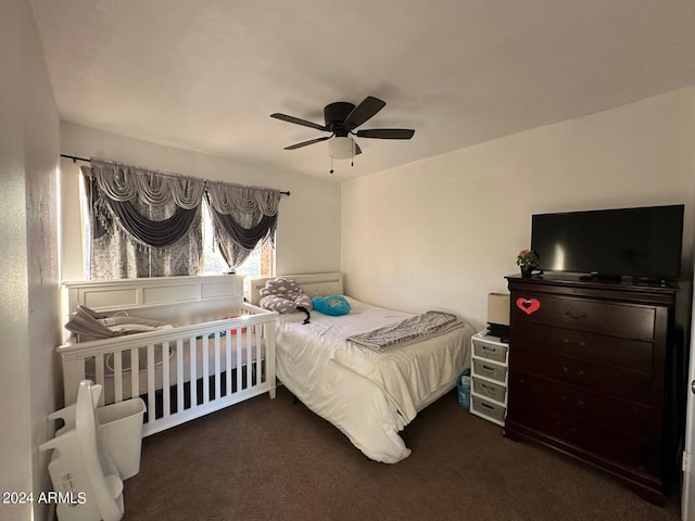 bedroom featuring dark colored carpet and ceiling fan