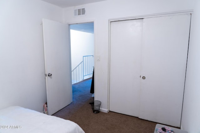 bedroom featuring a closet and dark carpet