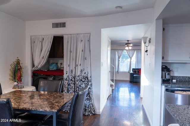 dining space with dark hardwood / wood-style flooring and ceiling fan