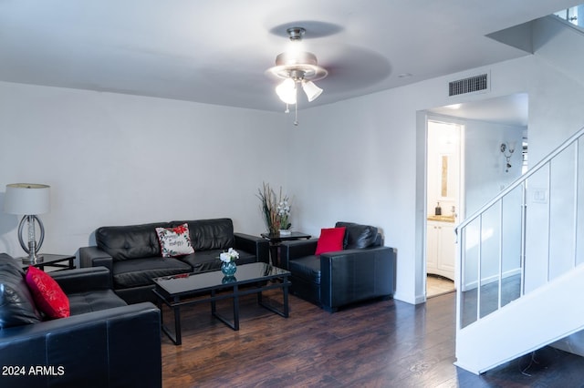 living room featuring dark hardwood / wood-style floors and ceiling fan