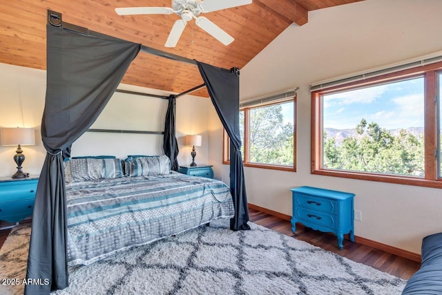 bedroom featuring vaulted ceiling with beams, ceiling fan, wood finished floors, and baseboards