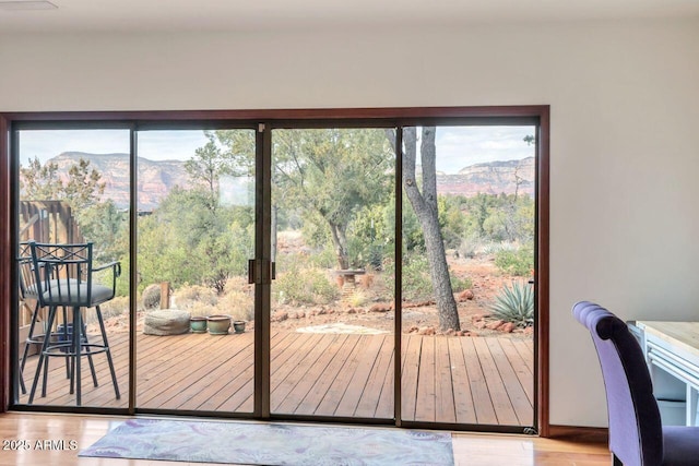 doorway to outside featuring wood finished floors and a mountain view