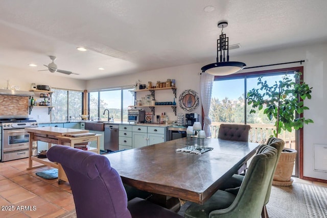 dining space featuring recessed lighting, a ceiling fan, a textured ceiling, and light tile patterned flooring