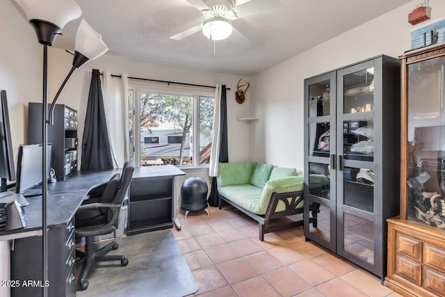 office space with light tile patterned floors and ceiling fan