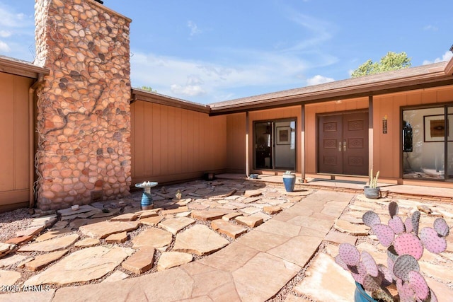 entrance to property with a chimney