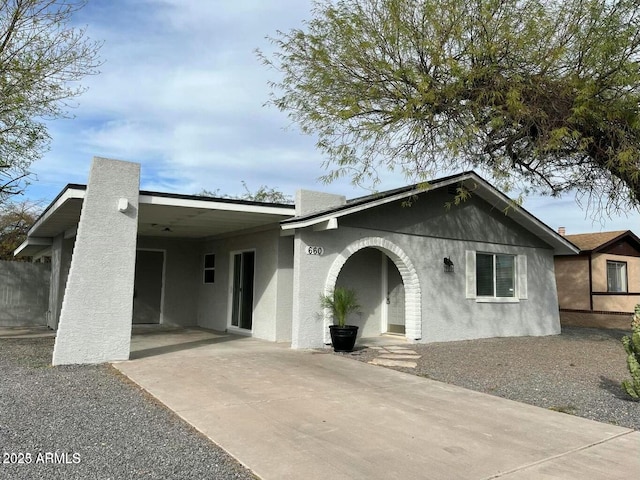 ranch-style house featuring a carport