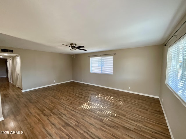 unfurnished room with dark wood-type flooring and ceiling fan