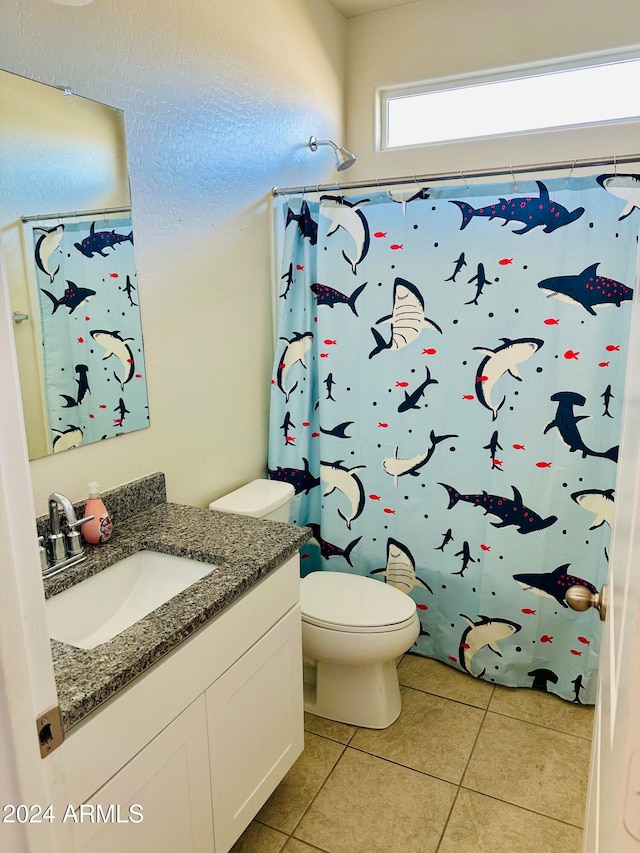 bathroom with walk in shower, tile patterned flooring, vanity, and toilet