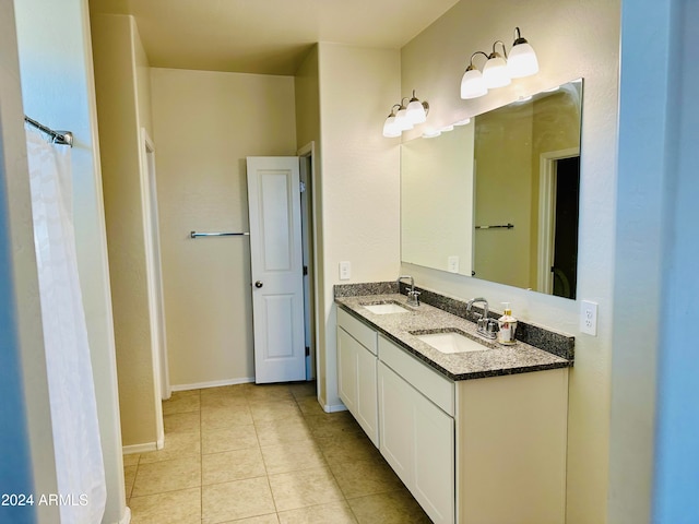 bathroom featuring tile patterned flooring and vanity