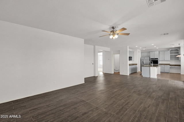 unfurnished living room featuring dark wood-style floors, recessed lighting, visible vents, and ceiling fan