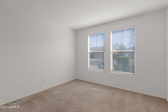 unfurnished room featuring light carpet