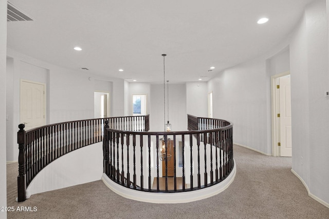 hall featuring visible vents, baseboards, light colored carpet, an upstairs landing, and recessed lighting