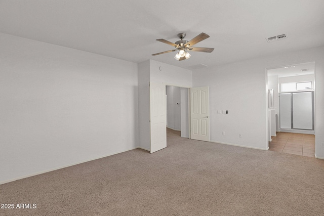 unfurnished bedroom with light carpet, visible vents, a ceiling fan, and ensuite bathroom