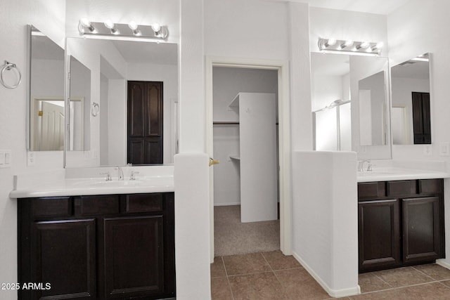 bathroom featuring two vanities, a sink, and tile patterned floors