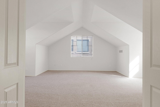 bonus room featuring carpet floors and lofted ceiling