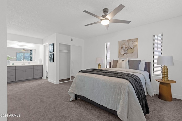 1075 E Chandler Blvd Unit 212, Chandler, AZ 85225 - bedroom with carpet floors, a closet, connected bathroom, a textured ceiling, and a ceiling fan