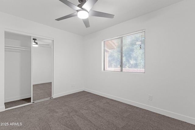 1075 E Chandler Blvd Unit 212, Chandler, AZ 85225 - unfurnished bedroom featuring dark colored carpet, a closet, and a ceiling fan