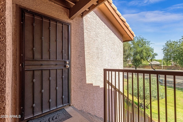 1075 E Chandler Blvd Unit 212, Chandler, AZ 85225 - view of exterior entry with stucco siding and a balcony