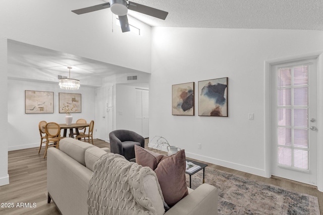 1075 E Chandler Blvd Unit 212, Chandler, AZ 85225 - living room with ceiling fan, wood finished floors, high vaulted ceiling, and a textured ceiling