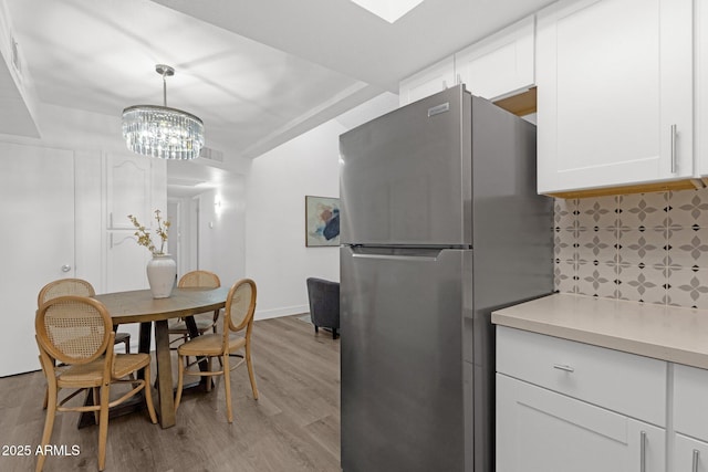 1075 E Chandler Blvd Unit 212, Chandler, AZ 85225 - dining space featuring light wood-style floors and a chandelier