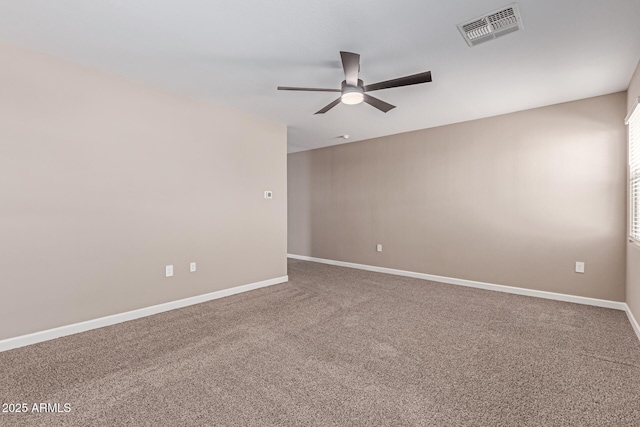 empty room featuring baseboards, ceiling fan, carpet flooring, and visible vents